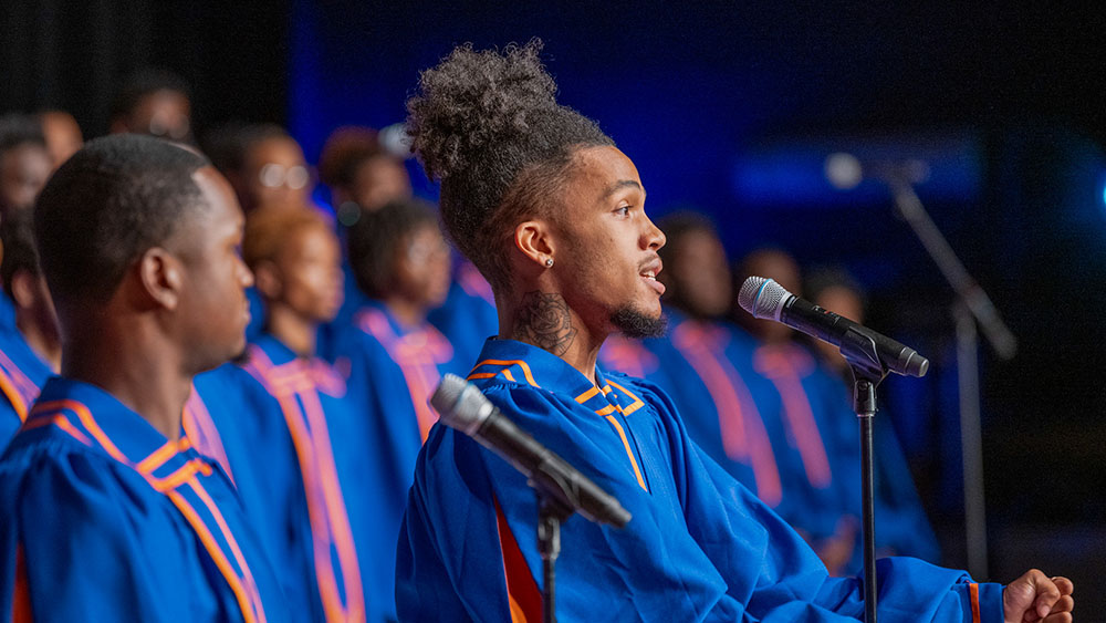 male choir member singing on a microphone